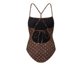 One-piece swimsuit with brown pattern on a white background